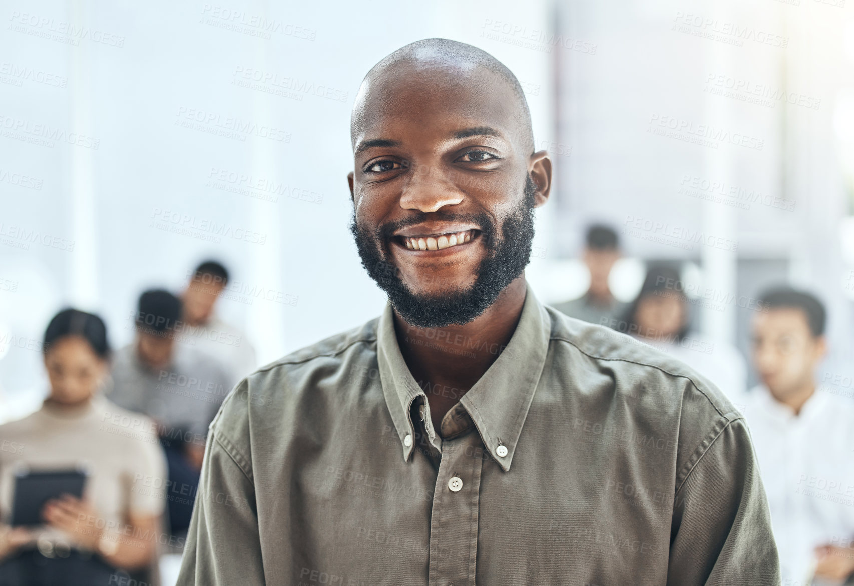 Buy stock photo Shot of a businessman smiling at a business meeting in a modern office