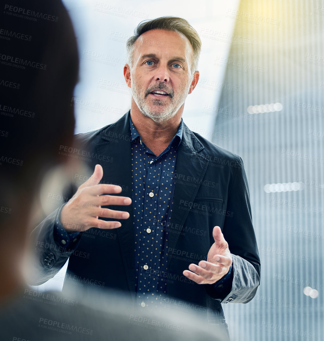 Buy stock photo Shot of a businessman giving his staff a training seminar