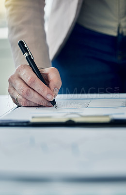 Buy stock photo Shot of an anonymous businessperson filling out paperwork