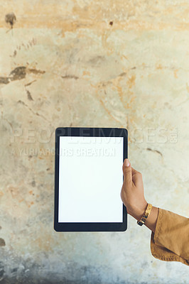 Buy stock photo Closeup shot of an unrecognisable woman holding a digital tablet with a blank screen against a wall