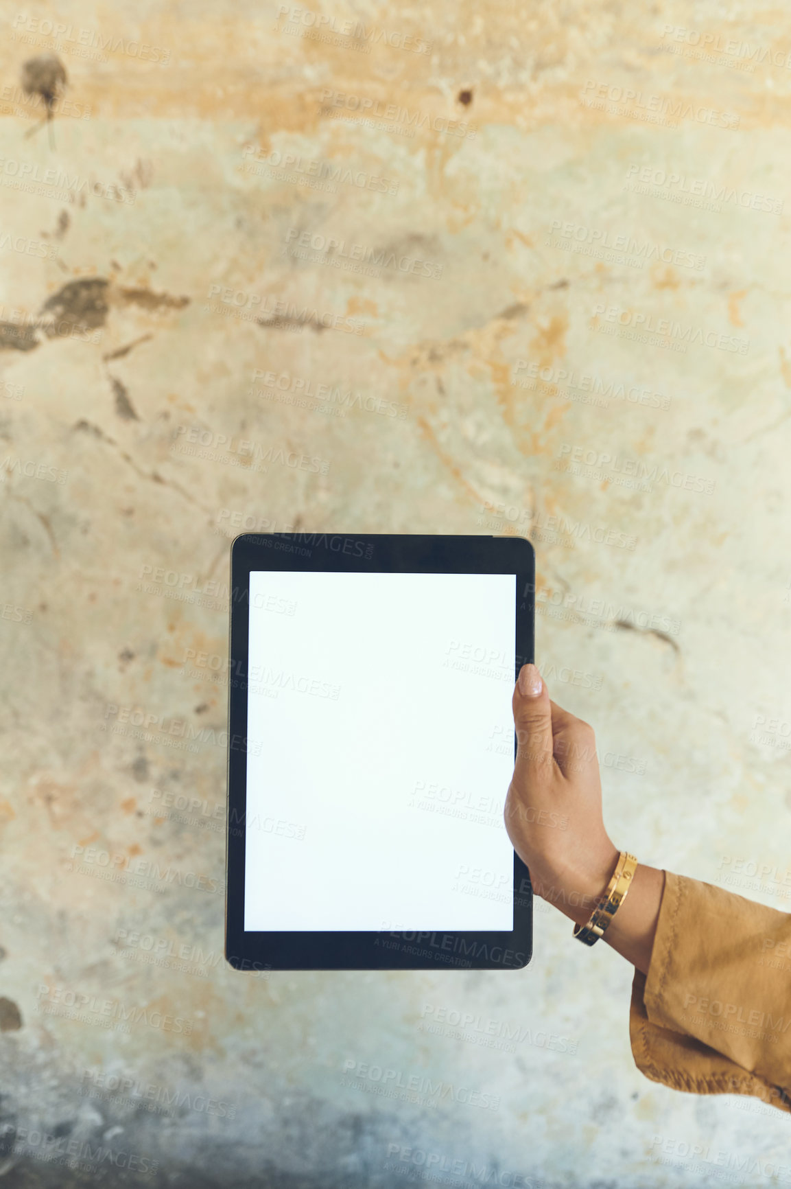 Buy stock photo Closeup shot of an unrecognisable woman holding a digital tablet with a blank screen against a wall