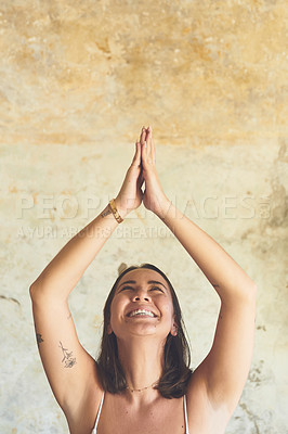 Buy stock photo Shot of a young woman meditating at home