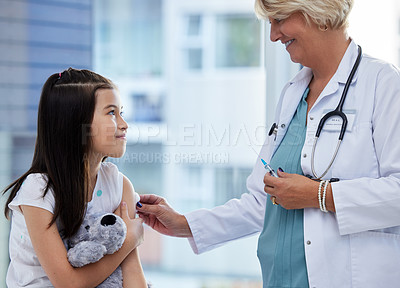 Buy stock photo Shot of a little girl getting a vaccination by a doctor in a hospital