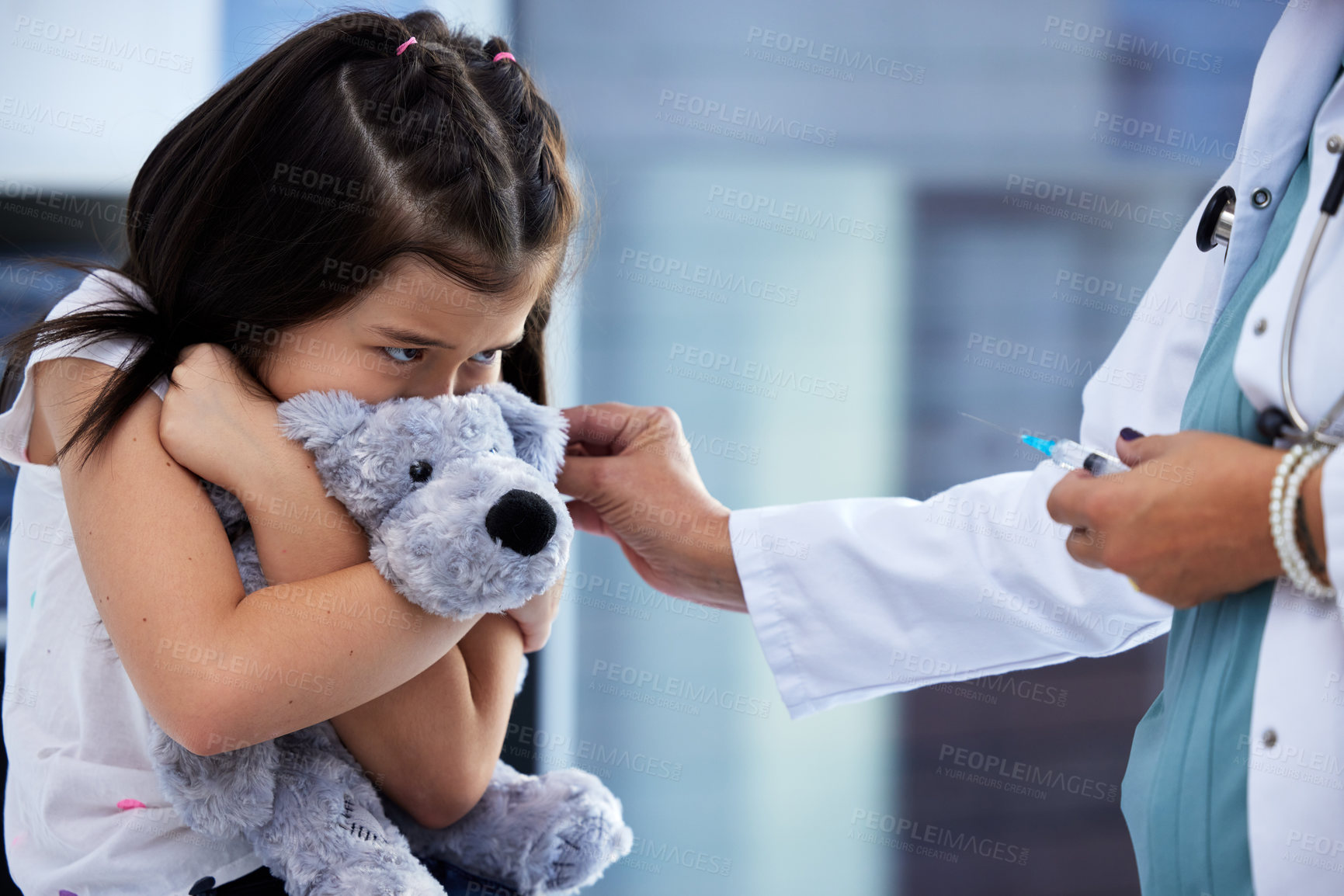 Buy stock photo Shot of a scared little girl getting a vaccination in a hospital