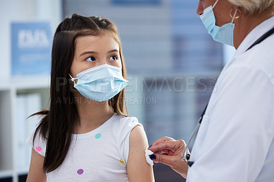 Buy stock photo Shot of a little girl getting a vaccination by a doctor in a hospital