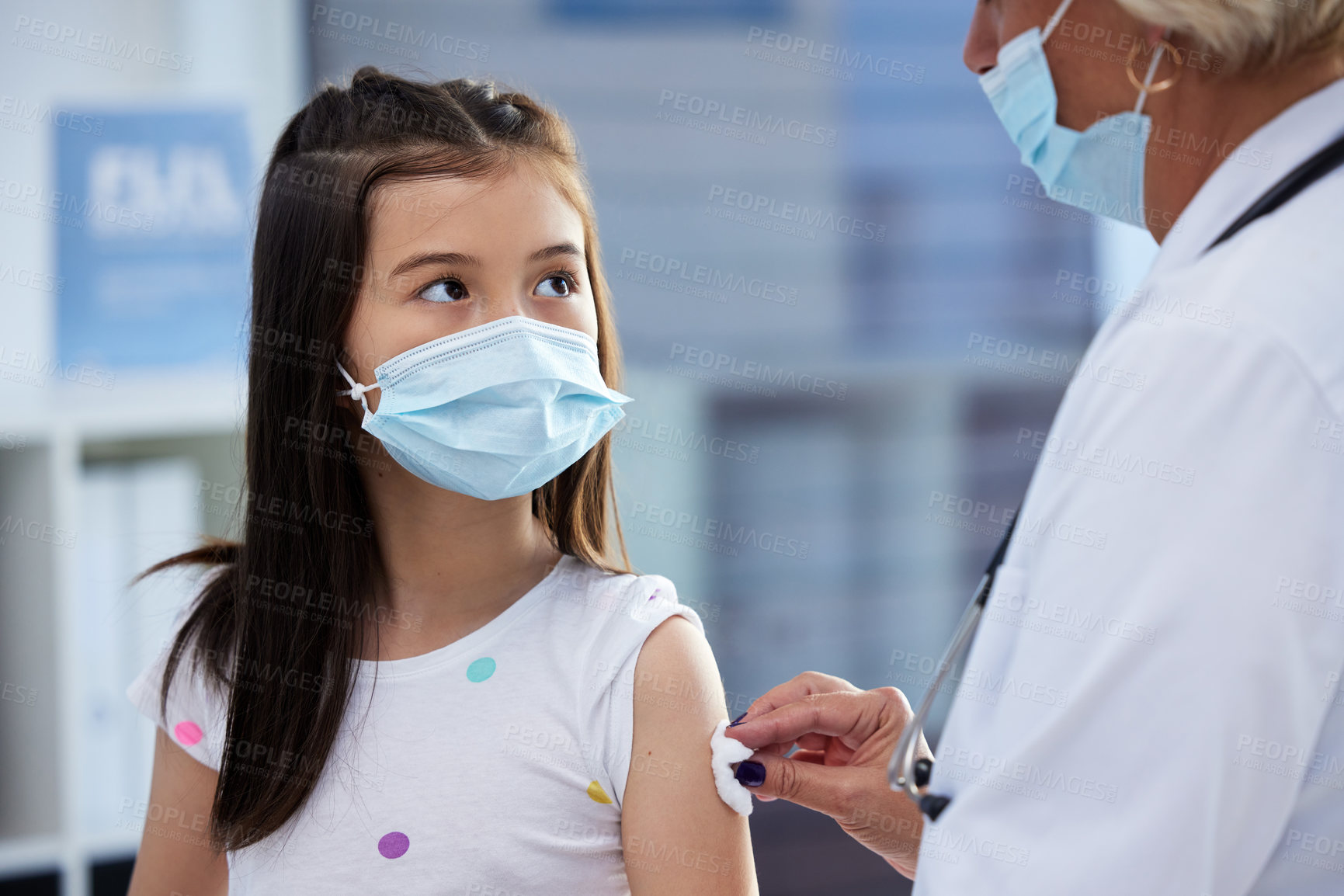 Buy stock photo Shot of a little girl getting a vaccination by a doctor in a hospital