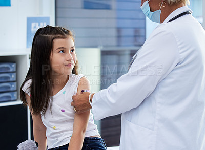 Buy stock photo Shot of a little girl getting a vaccination by a doctor in a hospital