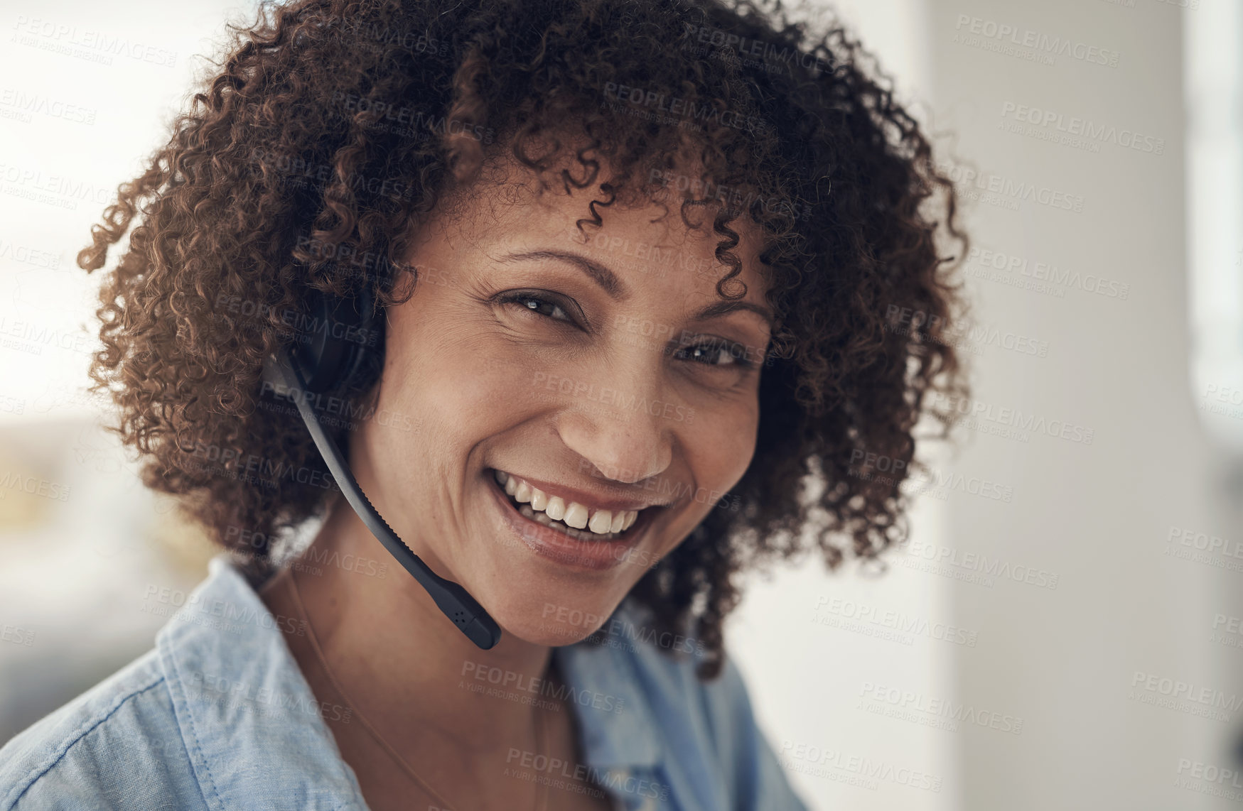 Buy stock photo Shot of an attractive young sitting alone at home and wearing headsets