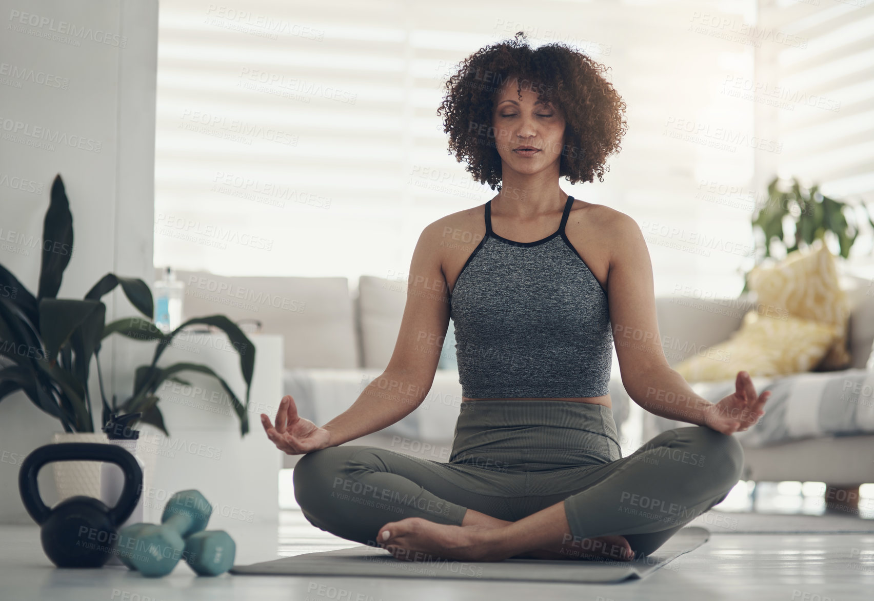 Buy stock photo Calm, woman and yoga mat with meditation in home for spiritual wellness or stress relief. Active, female person or zen with weights or lotus pose for inner peace, mindfulness or awareness in house