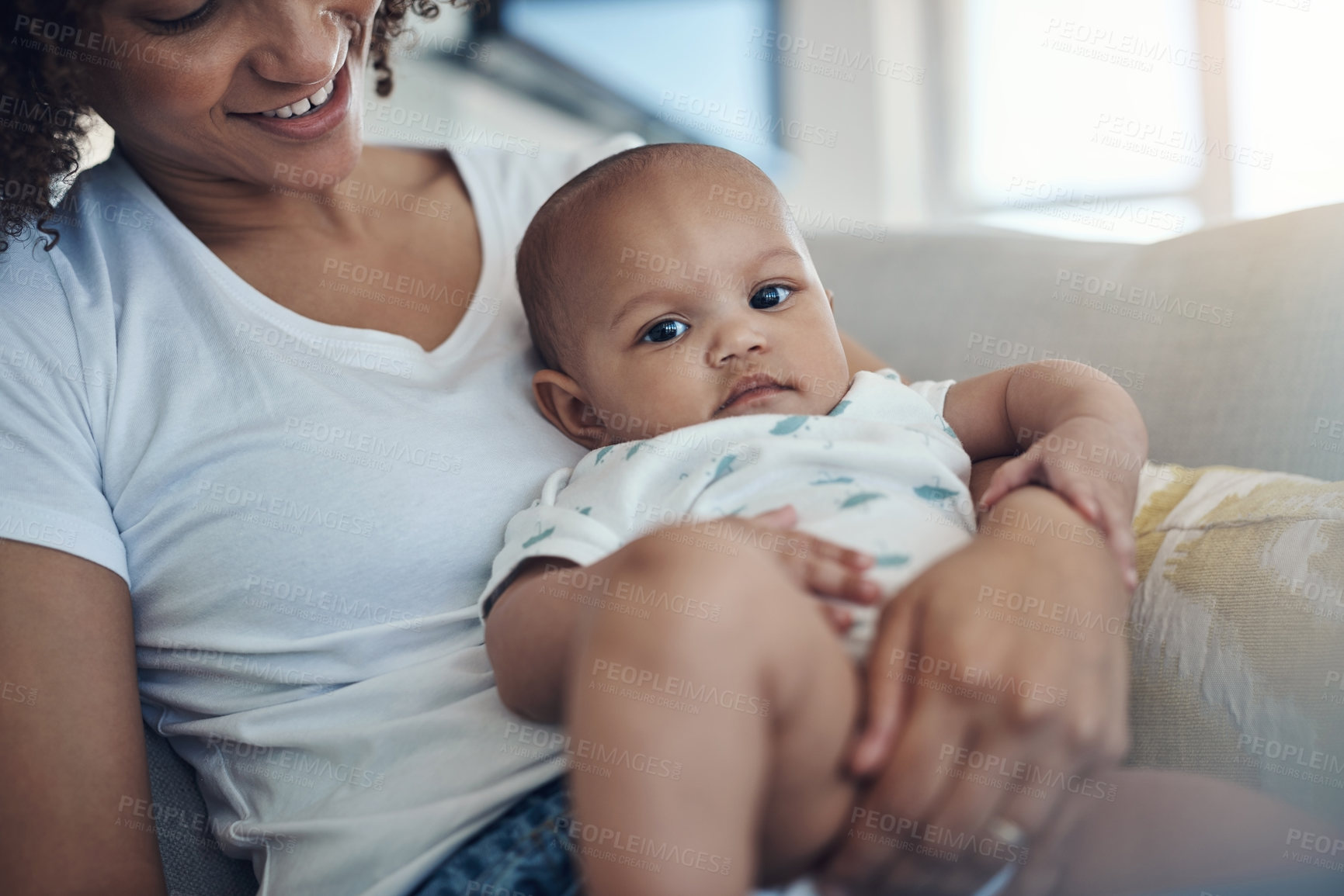 Buy stock photo Shot of a young woman relaxing with her adorable baby girl on the sofa at home