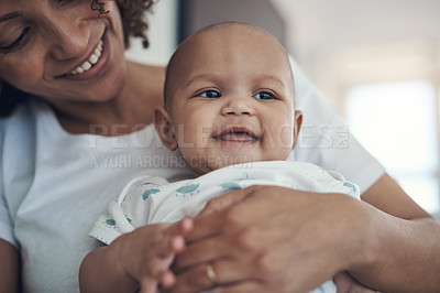 Buy stock photo Shot of a young woman relaxing with her adorable baby girl on the sofa at home