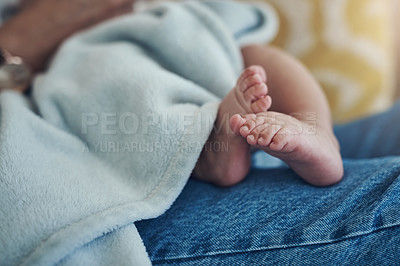 Buy stock photo Shot of an unrecognizable woman relaxing with her baby on the sofa at home