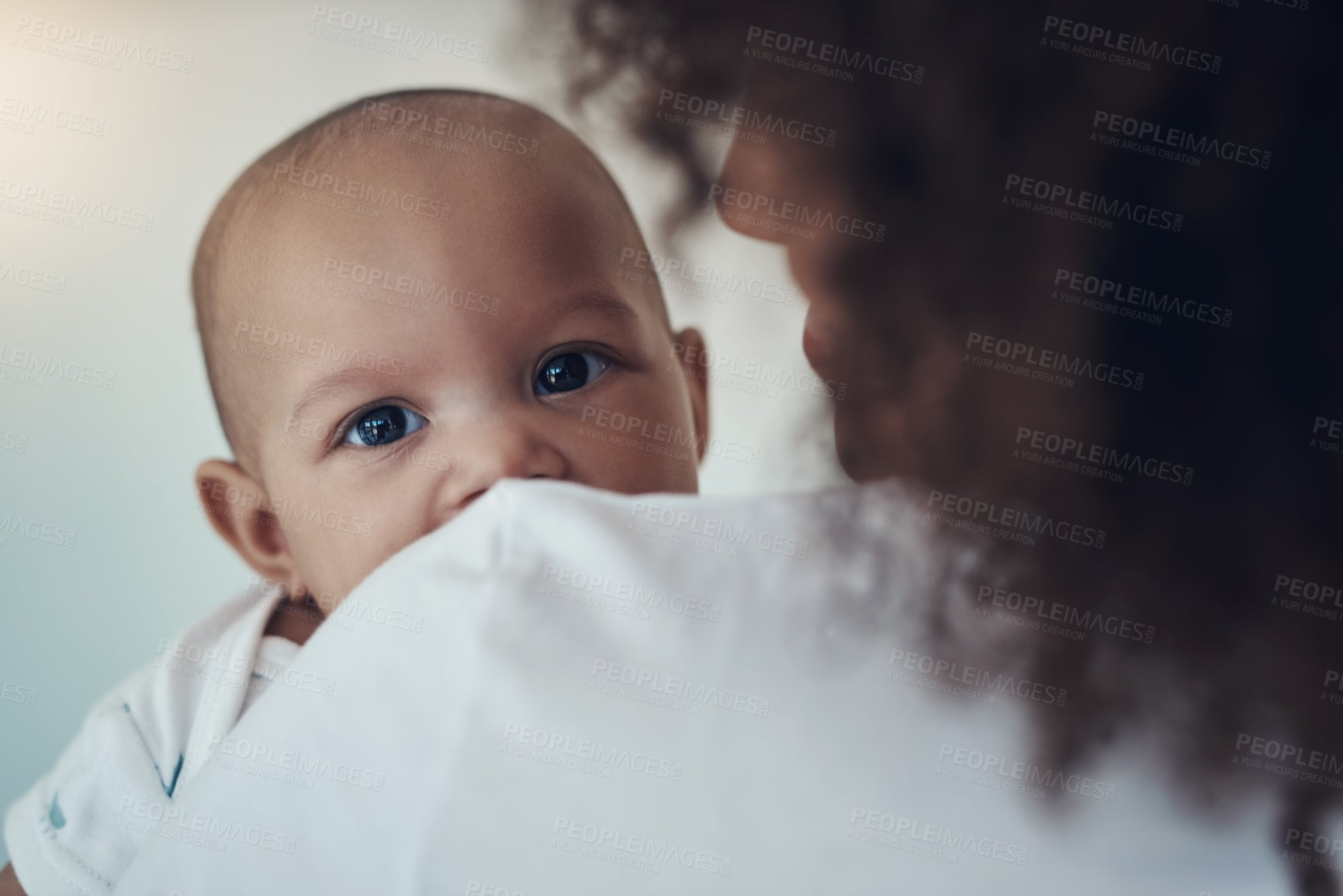 Buy stock photo Shot of a young woman carrying her adorable baby girl at home