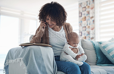 Buy stock photo Shot of a young woman using a smartphone and writing notes while caring for her adorable baby girl at home
