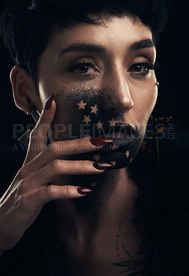 Buy stock photo Studio shot of a young woman posing with paint on her face on a grey background