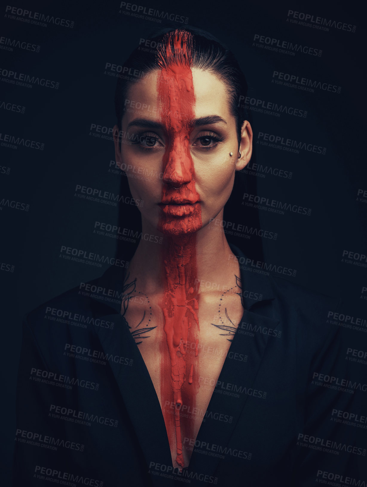 Buy stock photo Studio shot of a young woman posing with paint on her face on a black background