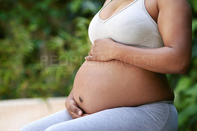Buy stock photo Cropped shot of a pregnant woman sitting outside in her exercise clothes