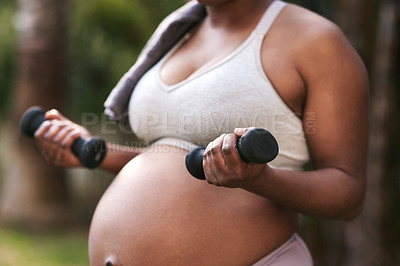 Buy stock photo Cropped shot of a pregnant woman working out with dumbbells