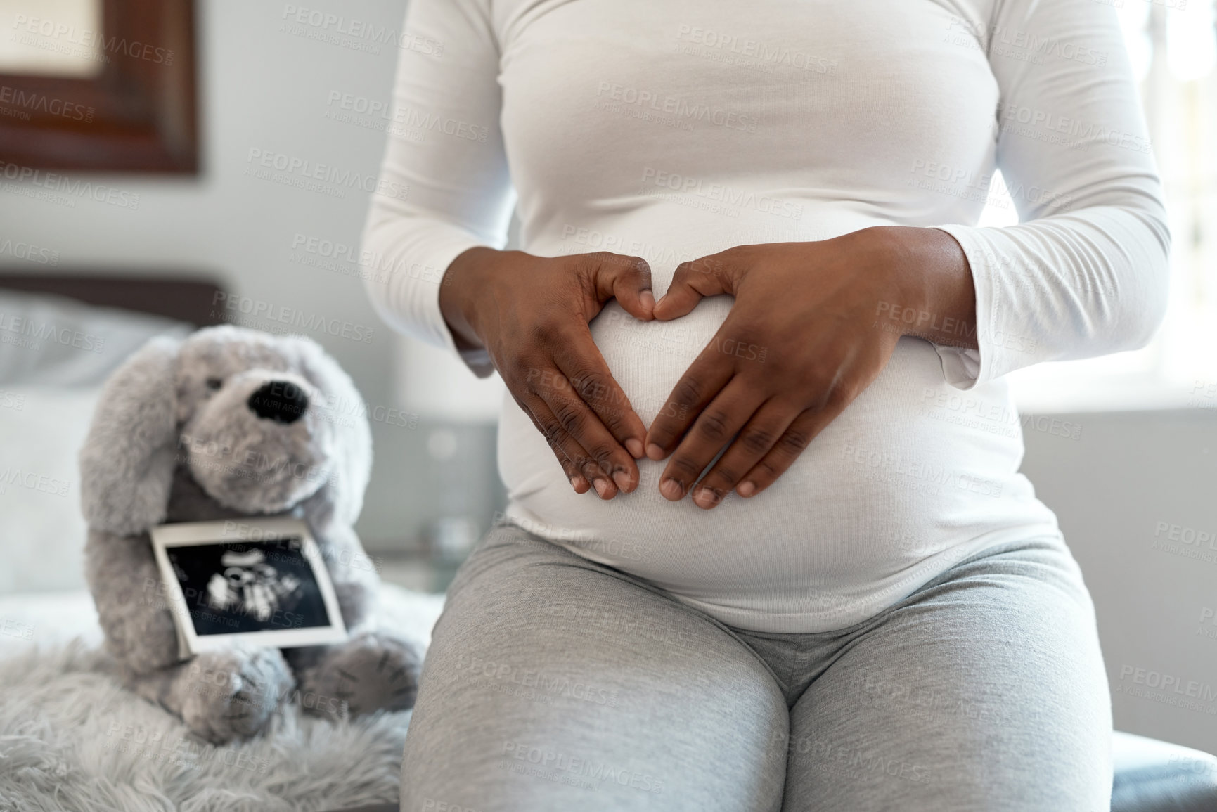 Buy stock photo Pregnant woman, hands or stomach with sonogram in home or nursery for ultrasound or motherhood. Female person, pregnancy or maternity with picture, heart or belly for trimester or parenthood in house