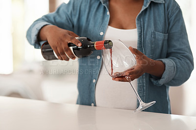 Buy stock photo Closeup shot of a pregnant woman pouring a glass of red wine at home