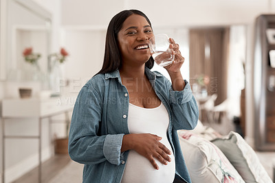 Buy stock photo Portrait of a pregnant woman drinking a glass of water at home