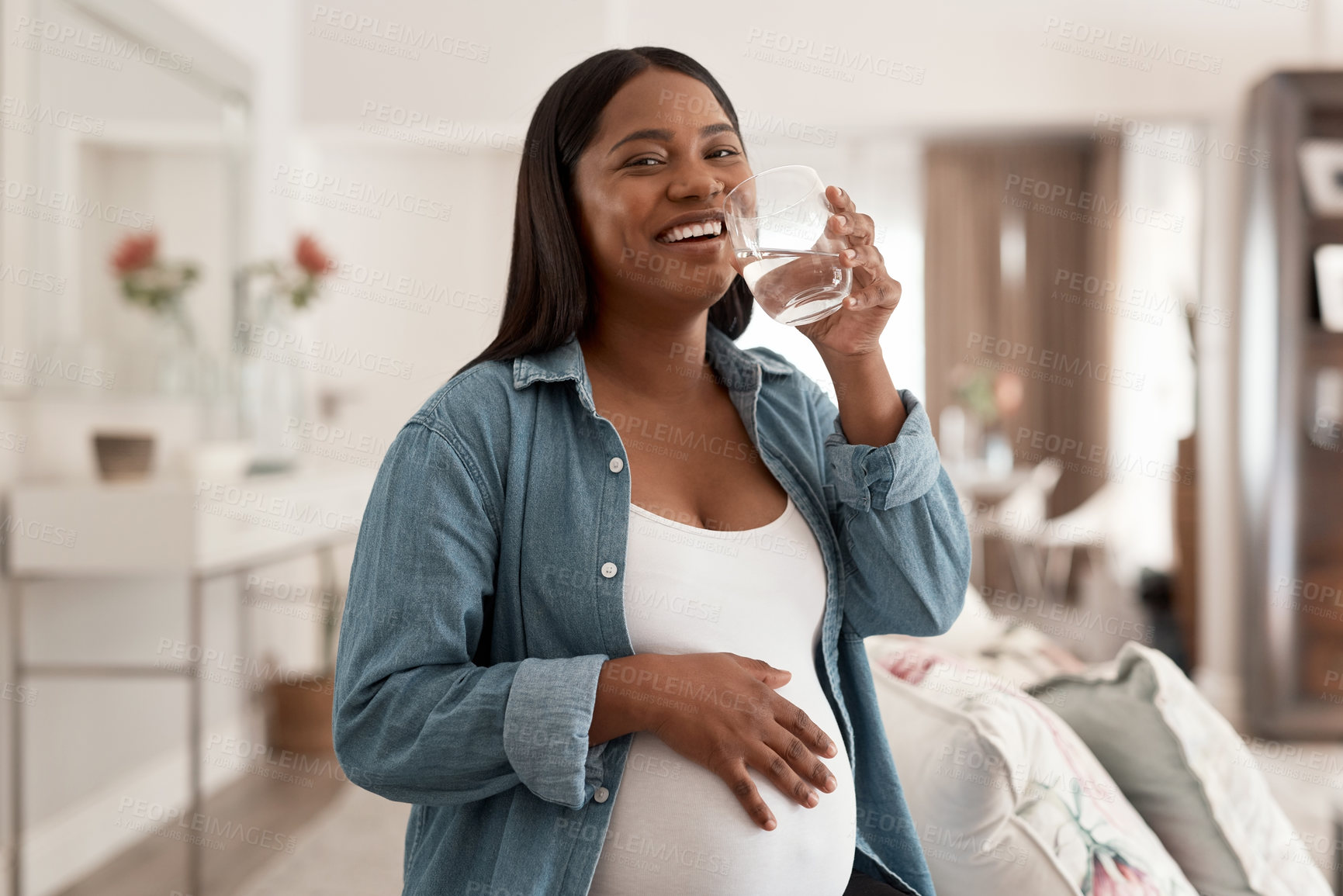 Buy stock photo Portrait of a pregnant woman drinking a glass of water at home