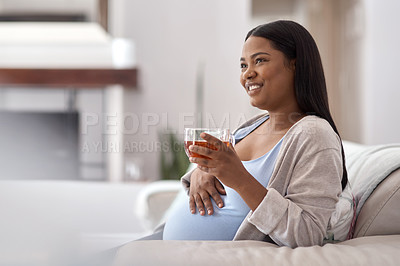 Buy stock photo Shot of a pregnant woman drinking tea and while sitting at home