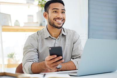 Buy stock photo Shot of a young man using his cellphone at work in a modern office