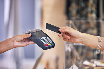 Buy stock photo Shot of a woman using her bank card to pay for a purchase in a store