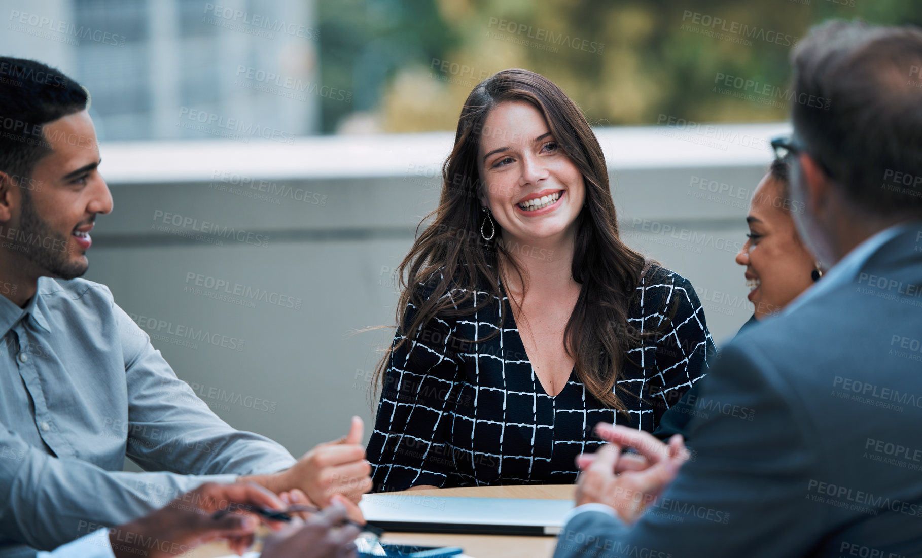 Buy stock photo Shot of a young businesswoman having a meeting with her colleagues on the balcony of an office