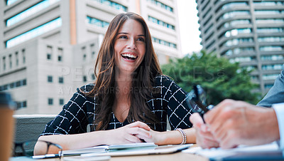 Buy stock photo Shot of a young businesswoman having a meeting with a colleague on the balcony of an office
