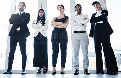 Buy stock photo Shot of a group of businesspeople with their arms crossed in an office