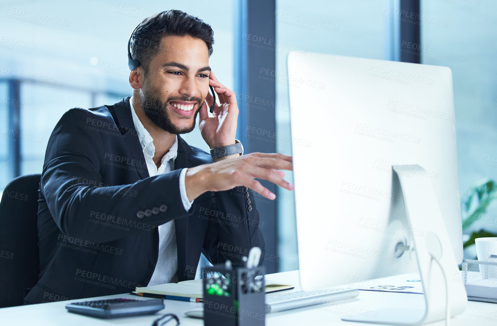 Buy stock photo Shot of a young businessman working in a call center