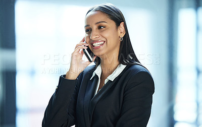 Buy stock photo Shot of a young businesswoman taking a call on her smartphone