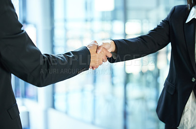 Buy stock photo Shot of two businesspeople shaking hands in agreement