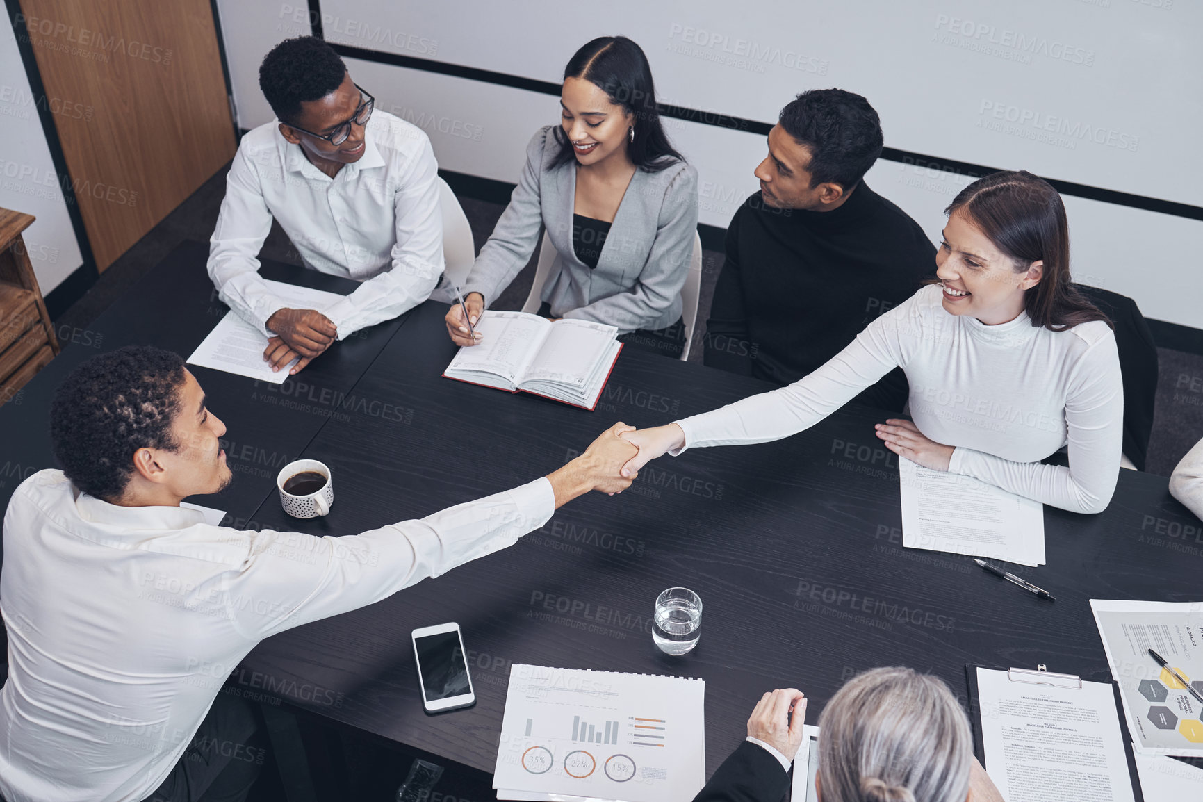 Buy stock photo Business people, handshake and teamwork in meeting for partnership, corporate growth or deal above at the office. Happy employees shaking hands for b2b, agreement or introduction at the workplace