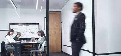Buy stock photo Shot of a businessman walking through his office