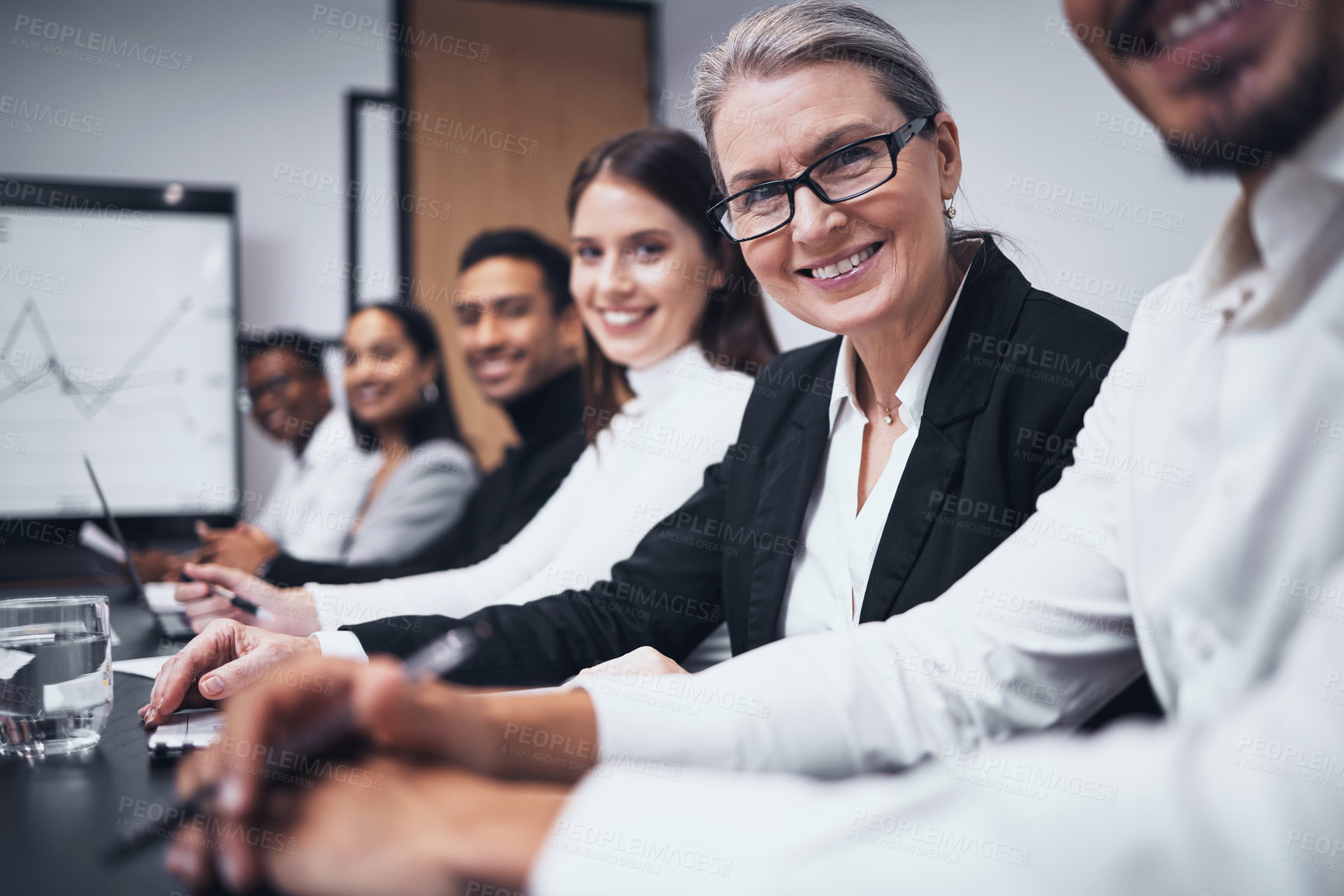 Buy stock photo Shot of a group of business people sitting together in their office