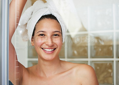 Buy stock photo Shot of a young woman standing with a towel wrapped around her head