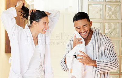 Buy stock photo Shot of a happy young couple going through their morning routine at home