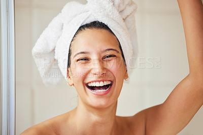Buy stock photo Shot of a young woman standing with a towel wrapped around her head