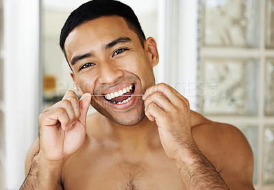 Buy stock photo Closeup shot of a handsome young man applying moisturiser to his skin