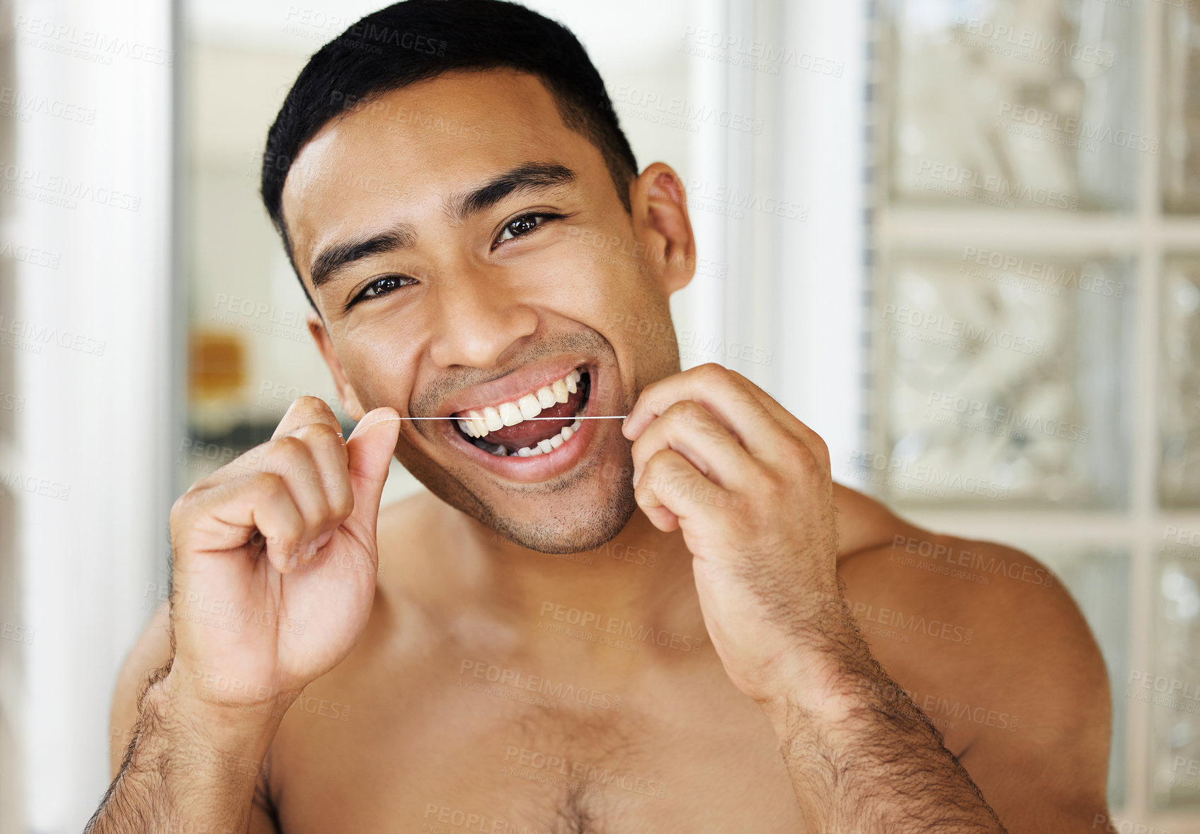 Buy stock photo Closeup shot of a handsome young man applying moisturiser to his skin
