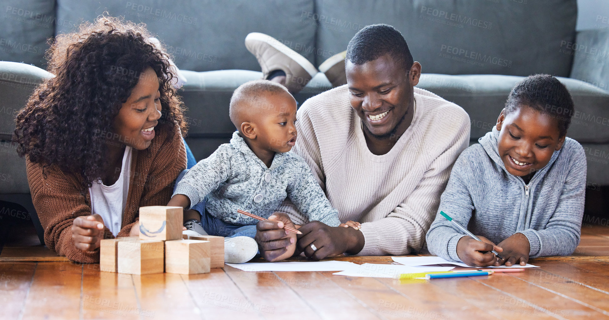 Buy stock photo Shot of a family playing together in the lounge at home