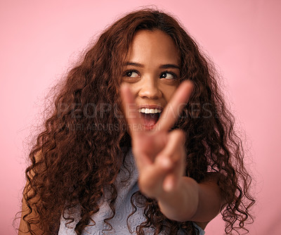 Buy stock photo Girl, happy and peace sign with hair in studio on pink background for treatment, growth and care. Teen, gen z and isolated with trendy or natural hairstyle, curls and soft with fresh texture

