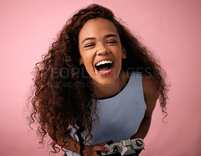 Buy stock photo Studio shot of a young woman laughing while holding her camera