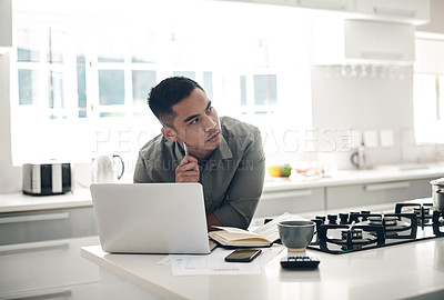 Buy stock photo Thinking, man and laptop in kitchen for planning, finances or investment budget for home maintenance. Person, contemplating and making notes in book for expenses, earnings and savings on house