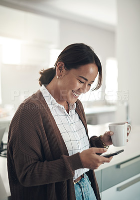 Buy stock photo Phone, smile and Asian woman drinking coffee in kitchen at home for breakfast in the morning. Smartphone, tea cup and happy person on social media, internet search and reading email on mobile app