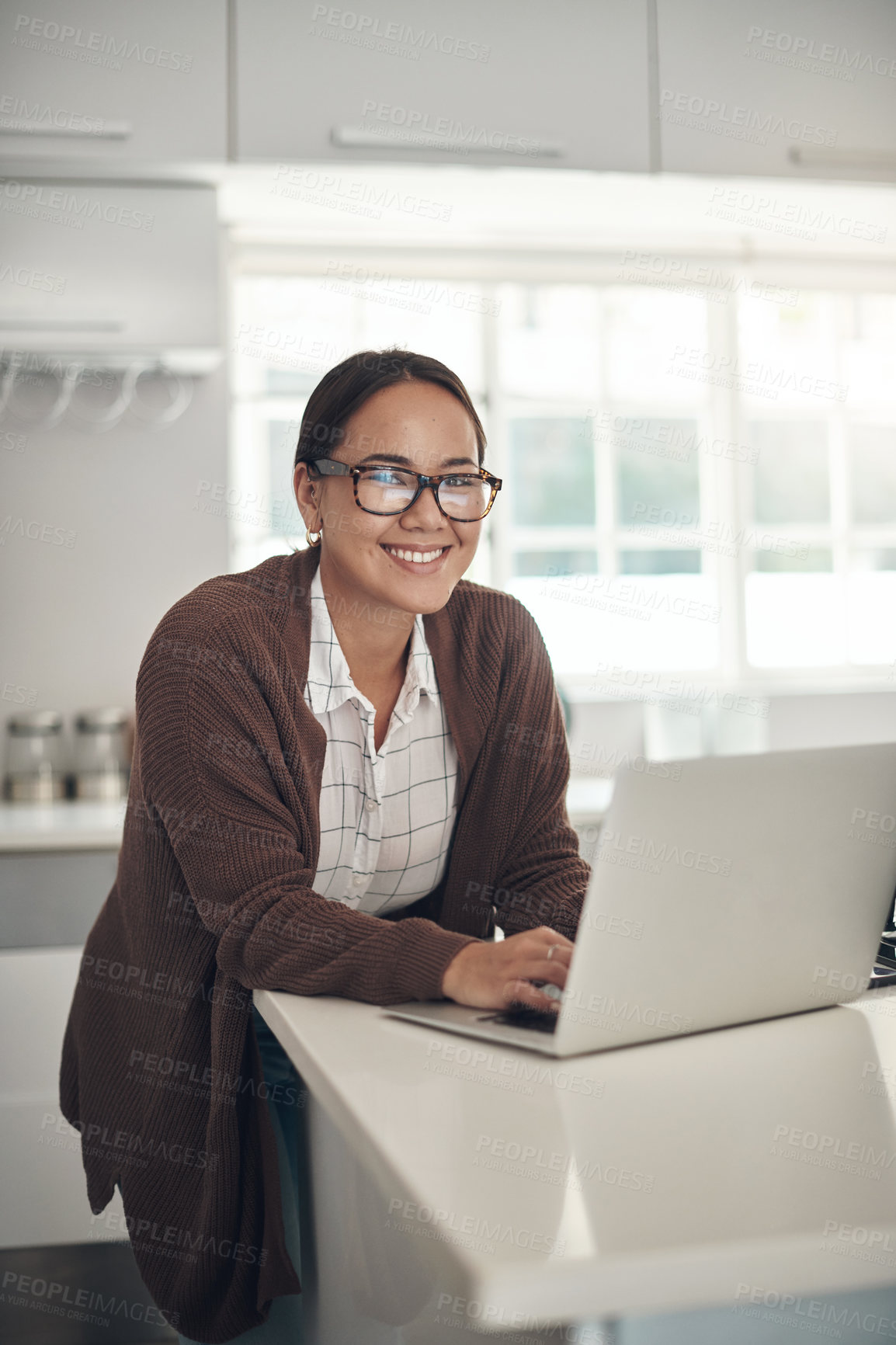 Buy stock photo Portrait, young woman and laptop in home with smile for small business, internet or online for work. Female person, happy and kitchen for workspace, digital or e commerce in technology for connection