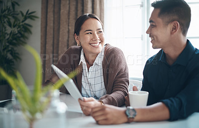 Buy stock photo Smile, relax and couple with tablet in home for social media update, communication and online search. Happy, asian people and technology with coffee for morning discussion, conversation and website